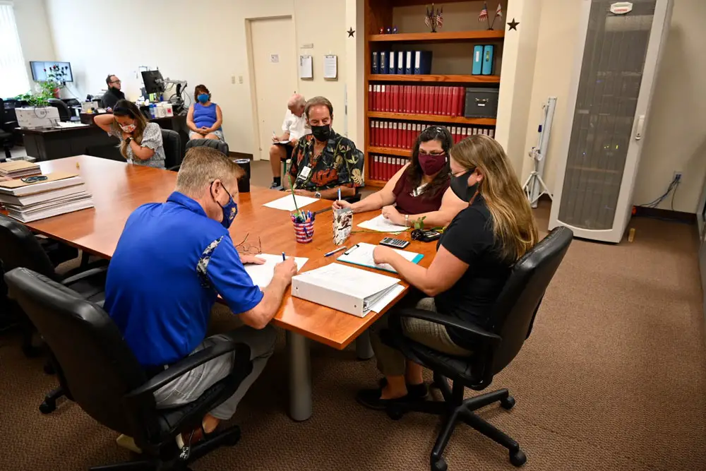 The Palm Coast Canvassing Board, with Supervisor of Elections Kaiti Lenhart, as its members were signing the document signifying the audit showed a hand-count that perfectly aligned. with the machine count. (© FlaglerLive)