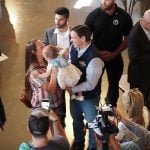 Ron DeSantis is handed a child by a parent attending his speech at Sun Valley Barn in Pella, Iowa, on May 31, 2023. He would win 21.3% of the vote in the Iowa caucuses. (Photo by Robin Opsahl/Iowa Capital Dispatch)