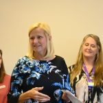 Flagler Cares CEO Carrie Baird, center, with Flagler Cares Board Chair JD Lebo, right, and Chief Operating Officer Rachael Gerow. (© FlaglerLive)