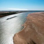 A barge maneuvers its way down the drought-narrowed Mississippi River at Tiptonville, Tenn., Oct. 20, 2022.