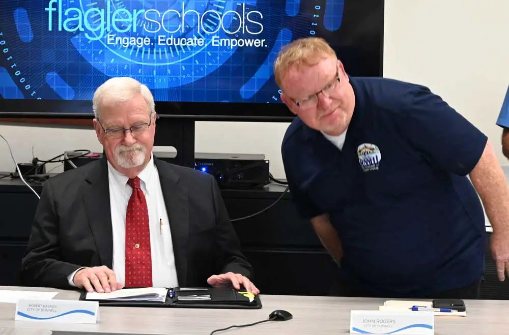 In what would be his next-to-last public appearance as a Bunnell City Commissioner, Robert Barnes, left, participated in a school-concurrency meeting on July 8 at the Government Services Building, representing Bunnell with fellow-Commissioner John Rogers. (© FlaglerLive)