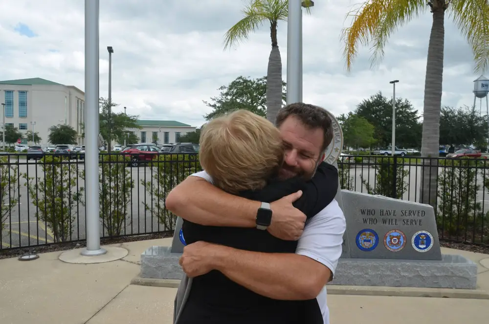 A hug worth a million appreciations: Bart Johnston congratulates his mother Suzanne Johnston in 2020, the day Suzanne won her re-election uncontested for the fourth straight time. It would prove to be her last election. (© FlaglerLive)