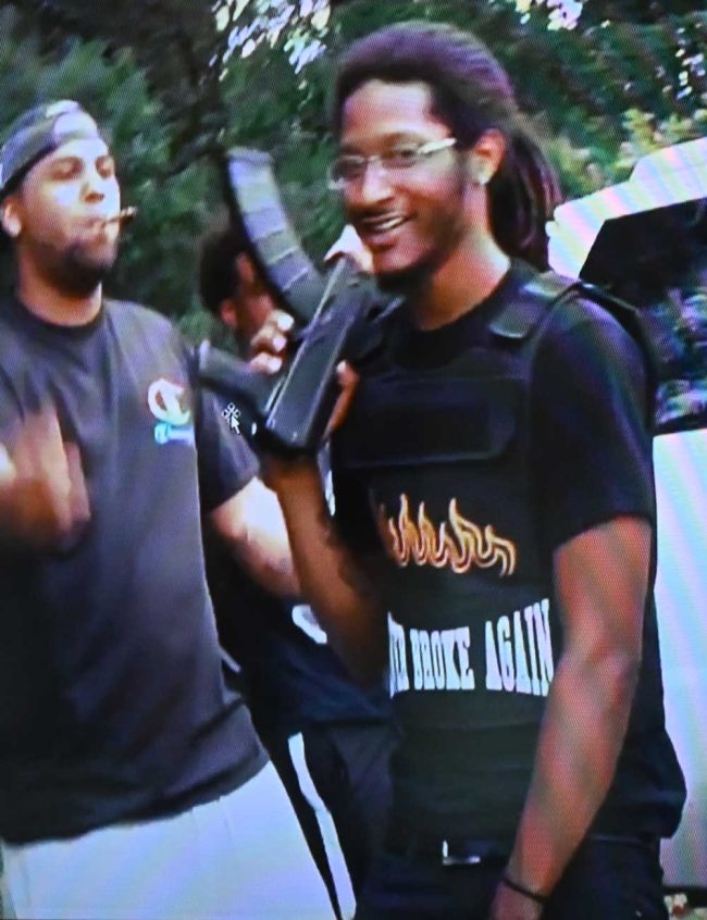 Bauer and Chamblin in a still from a rap video they made together before the shooting, with Chamblin holding what became the murder weapon. (© FlaglerLive)