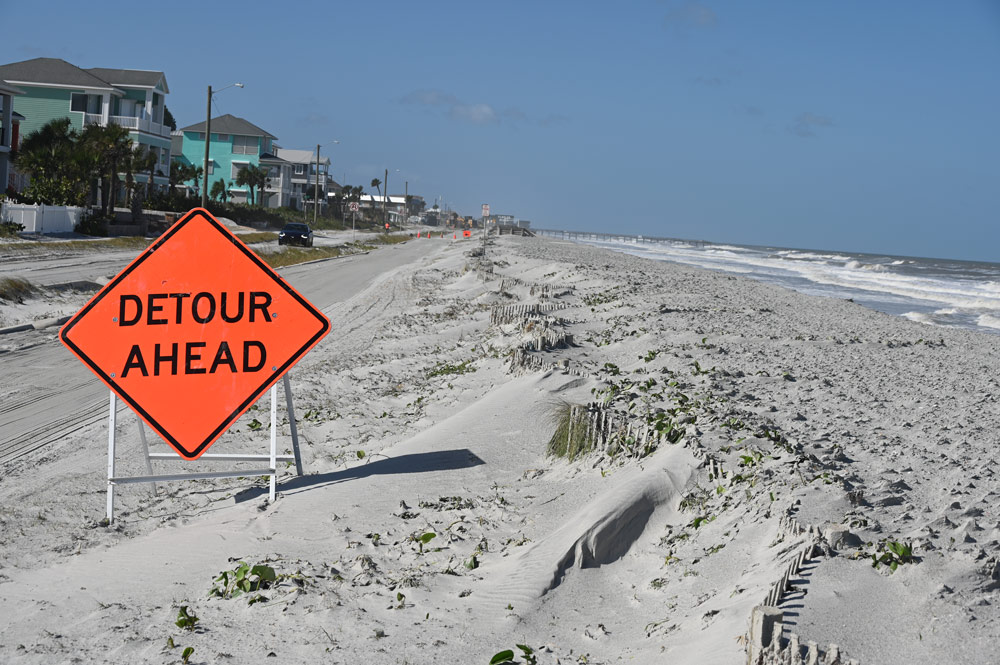 Shortly after the U.S. Army Corps of Engineers completed the renourishment of 3 miles of beach in Flagler Beach last summer, a storm blew a thick coating of sand onto State Road A1A. (© FlaglerLive)