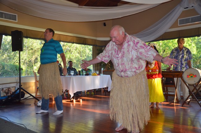 Palm Coast Fire Chief Mike Beadle, left, and Mayor Jon Netts, impressing Hawaiian gods at Sunday's fund-raiser for the Flagler Auditorium's arts in education fund. Click on the image for larger view. (© FlaglerLive) 