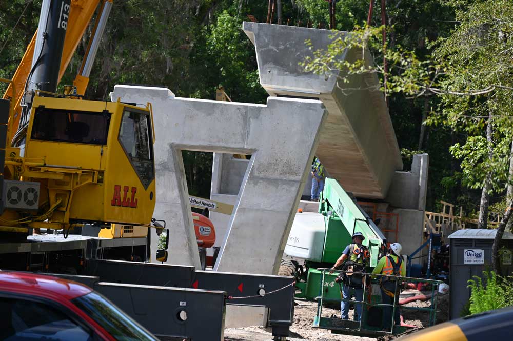 One of the colossal beams for the future pedestrian bridge over State Road 100 getting installed this morning by crane. (© FlaglerLive)