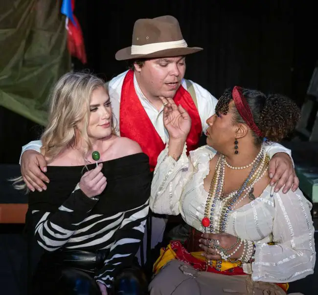 * Scapino (Beau Wade, center) slyly plans to help Giacinta (Joanne Gill, left) and Zerbinetta (Philippa Rose, right) escape the machinations of their fathers in the City Repertory Theatre production of the farce “Scapino!” Photo by Mike Kitaif