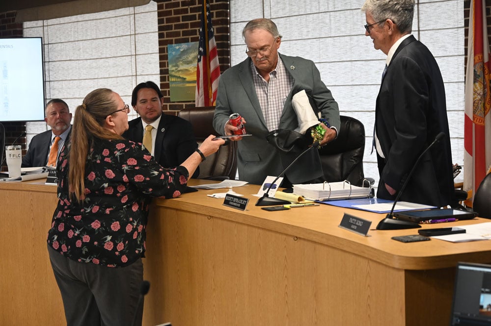 No-longer Commissioner Rick Belhumeur accepting his nameplate before stepping down from the dais last Thursday. (© FlaglerLive)