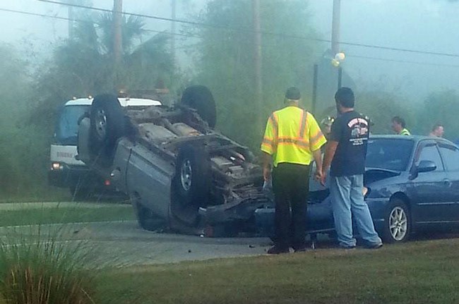 The pick-up truck blocked Belle Terre Parkway for about 40 minutes during Friday morning rush hour. (© Cayti Recker for FlaglerLive)