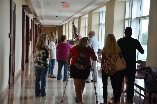 Dottye Benton, Cooper's owner, third from left, speaking with attorney and Palm Coast City Council member Vincent Lyon after today's hearing at the Flagler County courthouse. (© FlaglerLive)