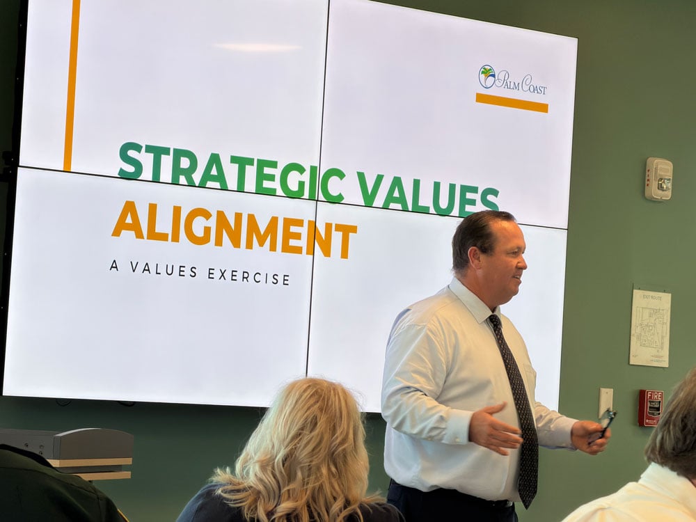 Acting Palm Coast Deputy City Manager Kyle Berryhill addressing the council and the city's directors at the Southern Recreation Center Monday. (© FlaglerLive)