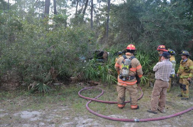 Berryhill, left, at a brushfire in 2013. (© FlaglerLive)