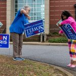 Campaign volunteers set up signs encouraging people to vote. AP Photo/Vasha Hunt