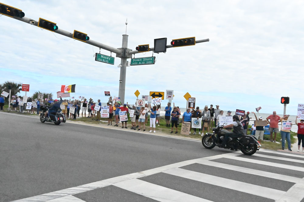 In Flagler Beach, protesters interact with Biketoberfest riders. (© FlaglerLive)