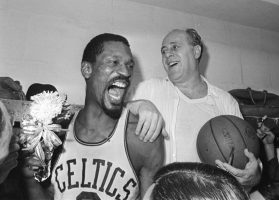 Bill Russell, left, celebrates with Celtics coach Red Auerbach after defeating the Los Angeles Lakers to win their eighth-straight NBA Championship, in Boston, April 29, 1966.