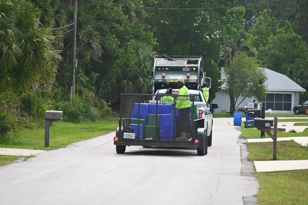 Waste Pro workers on their final runs in Palm Coast collected thousands of recycling bins the city considers to be residents' property. (© FlaglerLive)