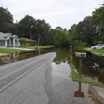 Water was rising Friday evening in places like Black Alder Drive in Palm Coast's Woodlands, and city officials are fearful that the water, overflowing from Graham Swamp, may keep rising for a while. (© FlaglerLive)