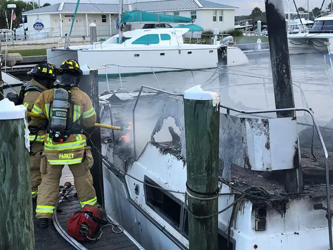 Flagler County firefighters battling the blaze on one of the two boats this afternoon in Marineland. (Flagler Professional Firefighters Firefighters)