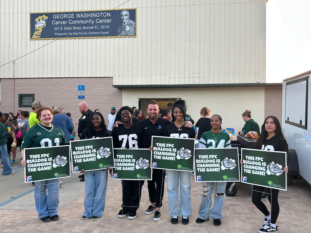 FPC Principal Bobby Bossardet, center, with some of the students who turned up for the 6th annual Bulldog Block Party at the Carver Center last week. (Flagler Schools)