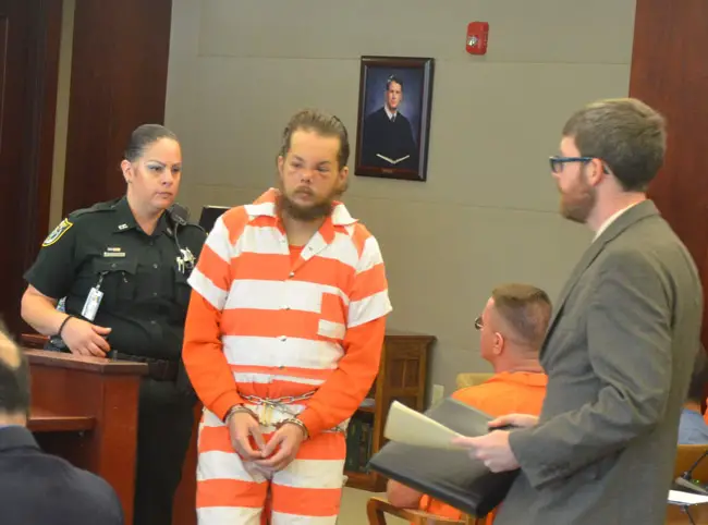 Joseph Bova, center, with his attorney, Joshua Mosley, right, in Bova's last court appearance in April. He has been at the Flagler County jail since, but his mental state is unclear. (© FlaglerLive)