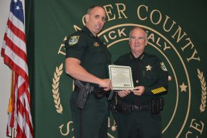 Paul Bovino, left, getting a commendation for his role as incident commander during the search for Ricky Wheeler. (© FlaglerLive)