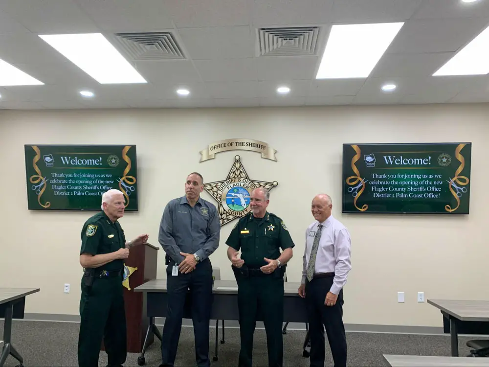 From left, Chief Mark Strobridge, Chief Paul Bovino, Sheriff Rick Staly and County Commission Chairman Donald O'Brien in the new precinct today. (© FlaglerLive)