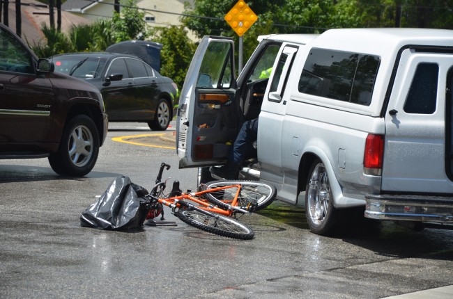 The boy's bike and the SUV that struck it, minutes after the collision, in the middle of Belle Terre Parkway.  Click on the image for larger view. (© FlaglerLive)