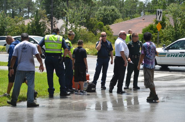 The young boy was hurt in the leg but was was walking and appeared in good spirits as paramedics surrounded him. Click on the image for larger view. (© FlaglerLive)