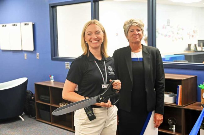 Matanzas High School Principal Kristin Bozeman and Superintendent cathy Mittelstadt ready for the ribbon-cutting this morning, with some two dozen guests. The five school board members were all invited. None showed. (© FlaglerLive)