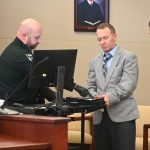 Brian Pirraglia getting fingerprinted immediately after trial, in his last minutes wearing civilian clothes. He will not get to do so for the rest of his life in prison. (© FlaglerLive)