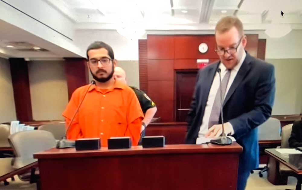 Brian Lemus, left, in court today with his attorney, Jeffrey Higgins. (© FlaglerLive via court video)