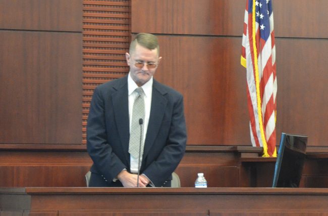 Bruce Haughton during his testimony today in his own defense. He asked to stand up at one point, saying his back was hurting from a debilitating pain, though he had spent all three days of trial until then sitting at his defense chair for long stretches but for occasional breaks. (c FlaglerLive)