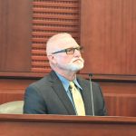 Flagler County Sheriff's deputy Bryan "Scotty" Jackson, seen here testifying during his son's sentencing on a hit-and-run conviction last June, was shooting target practice in his backyard earlier this week, with his daughter, sheriff's deputy Jackson, when a bullet struck an 11-year-old boy in a neighboring house. (© FlaglerLive)