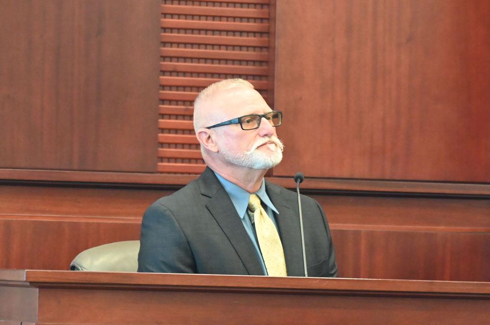 Flagler County Sheriff's deputy Bryan "Scotty" Jackson, seen here testifying during his son's sentencing on a hit-and-run conviction last June, was shooting target practice in his backyard earlier this week, with his daughter, sheriff's deputy Jackson, when a bullet struck an 11-year-old boy in a neighboring house. (© FlaglerLive)