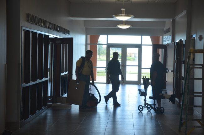 Workers outside Palm Coast government's building department as City Hall was getting ready to open in 2015. (© FlaglerLive)