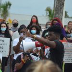 The second march of the day, in Flagler Beach, drew upwards of 300 people and featured a series of speakers at Veterans Park, among them Henry. (© FlaglerLive)