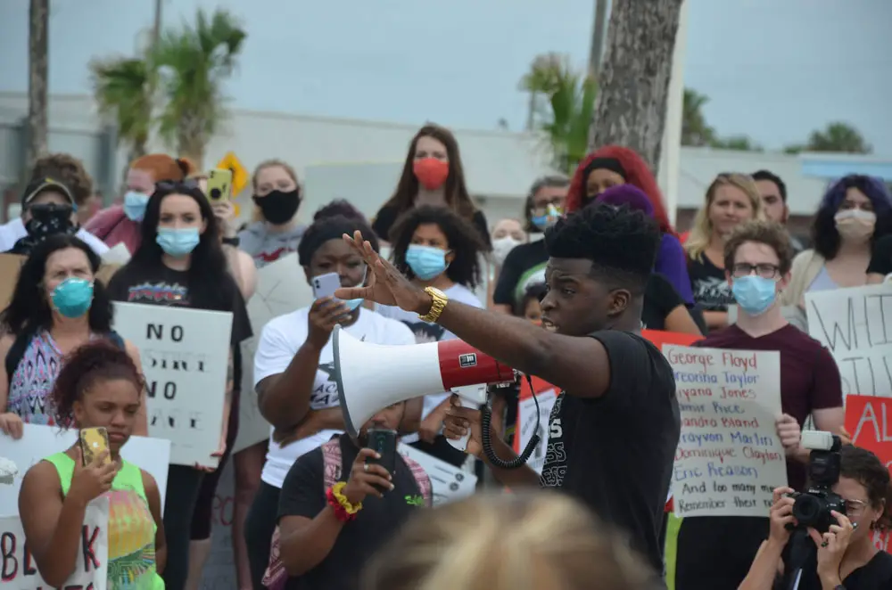  The second march of the day, in Flagler Beach, drew upwards of 300 people and featured a series of speakers at Veterans Park, among them Henry. (© FlaglerLive)