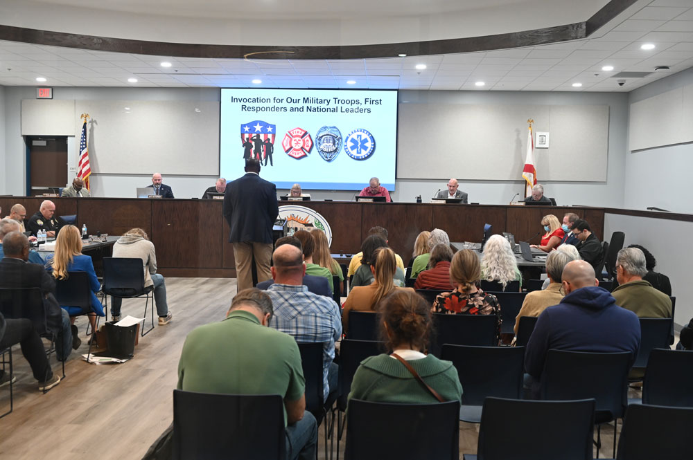 A prayerful Bunnell City Commission on Monday before spending most of a nearly three-hour meeting on an industrial rezoning of historic proportion. (© FlaglerLive)