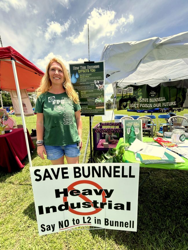 Katherine Biancaniello manned a booth opposing a proposed rezoning in Bunnell. (© FlaglerLive)