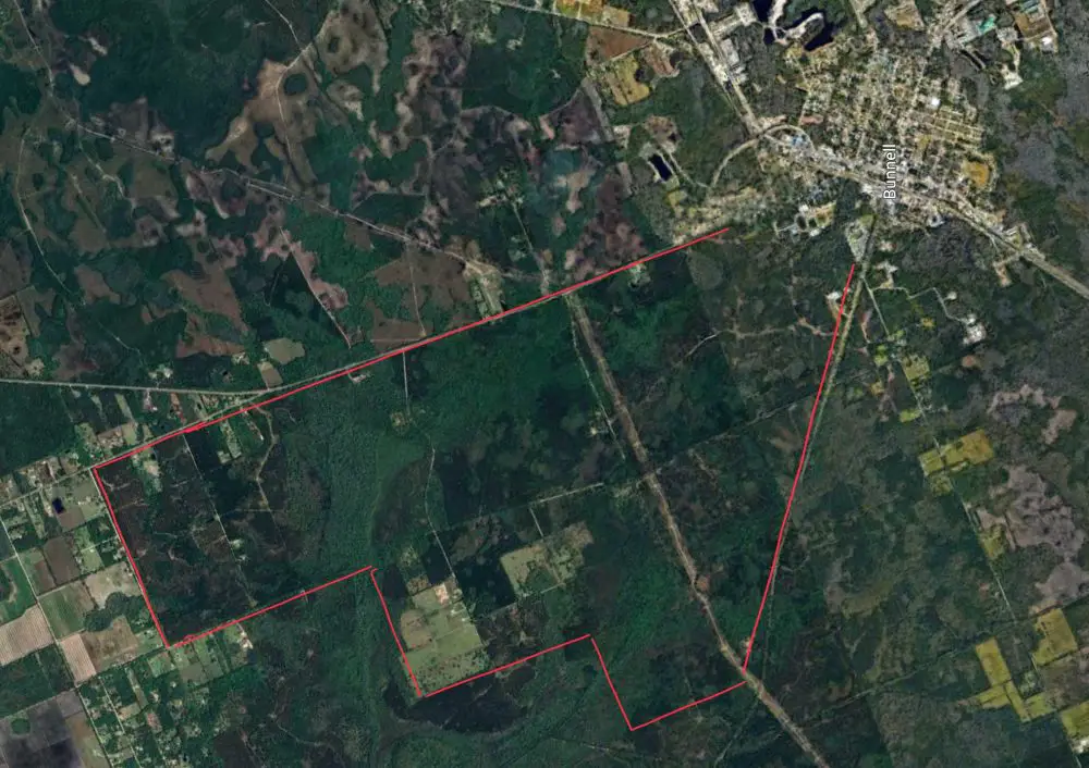 The proposed development currently called Preserve at Haw Creek would sprawl form the existing Bunnell's urban core west and southwest, within the estimated boundaries in red. (© FlaglerLive via Goggle Earth)