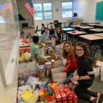 Bunnell Elementary School students this week preparing some of the 81 boxes of goodies for shipment to U.S. servicemen overseas. (Carmen Sanford)