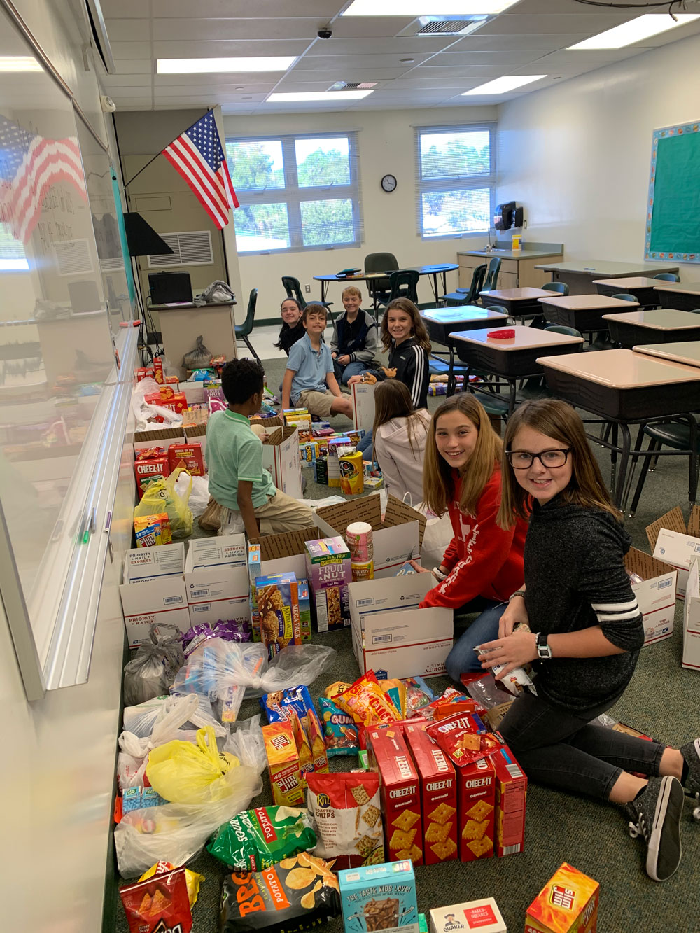 Bunnell Elementary School students this week preparing some of the 81 boxes of goodies for shipment to U.S. servicemen overseas. (Carmen Sanford) 