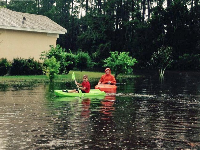 Austin McKay and his father Brian today on Burbank Drive in Palm Coast. Click on the image for larger view. (c Angela McKay for FlaglerLive)