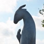 ‘Burro With Bird on Shoulder,’ a bronze sculpture by artist Copper Tritscheller, in Palm Coast's Central Park. (© FlaglerLive)