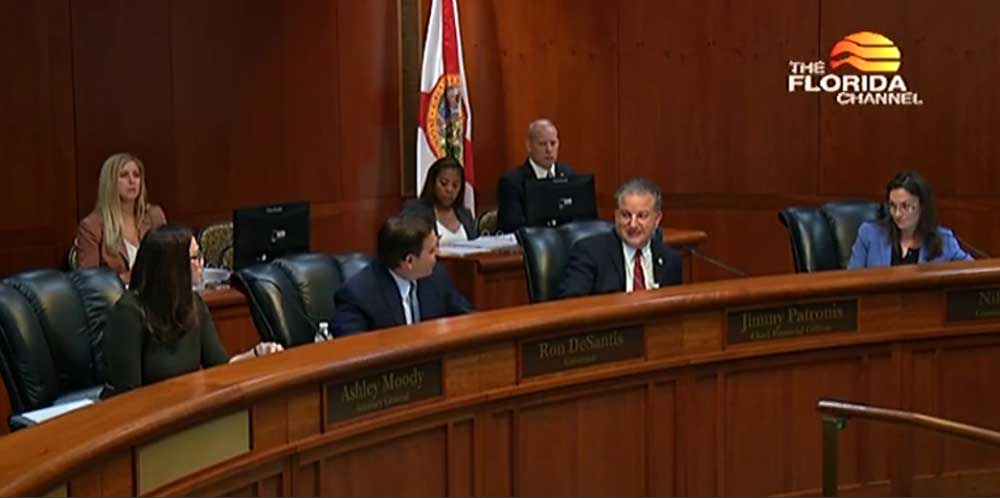 Agriculture and Consumer Affairs Secretary Nikki Fried, at right, challenged Gov. Ron DeSantis during a Florida Cabinet meeting on June 15, 2021. (Screenshot/Florida Channel)