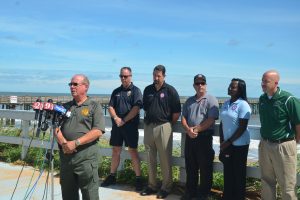 County and city officials in a show for the cameras Sunday in Flagler Beach, with each taking the mic in turn. Flagler County Sheriff Jim Manfre rode with Gov. Scott today. He did not return a call asking for details of his conversations with the governor. Click on the image for larger view. (c FlaglerLive)