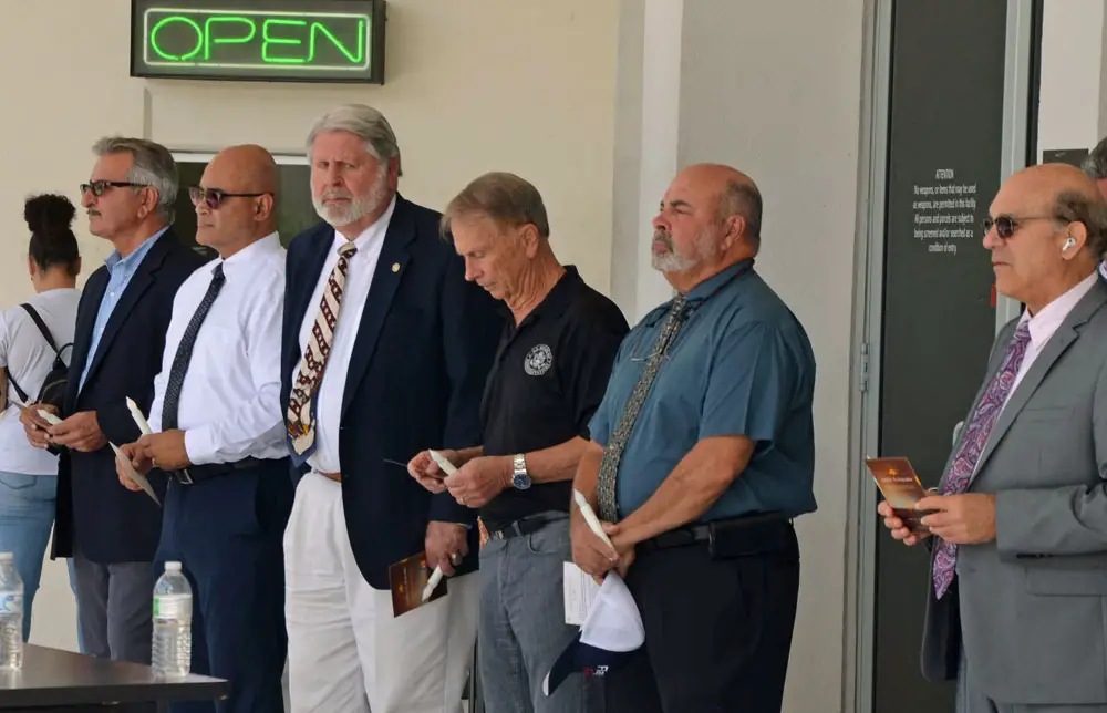 Jerry Cameron, fourth from right, at a recent county event, standing next to Jorge Salinas, the chief of staff and incoming interim county administrator. Cameron is ending his tenure in that role after two years and four months. (© FlaglerLive)
