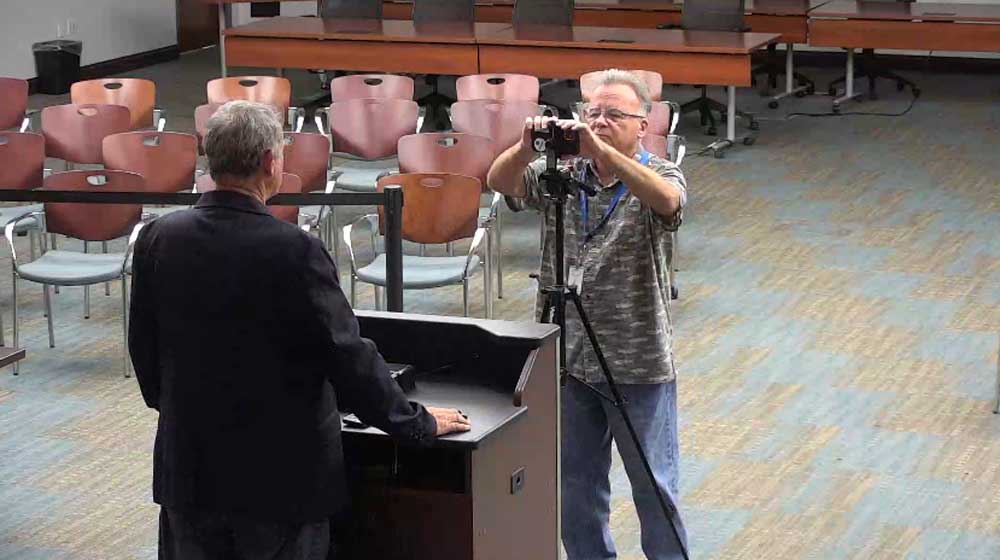 Ed Danko using City Hall's chamber two years ago to film a campaign video or Alan Lowe. (© FlaglerLive via Palm Coast)