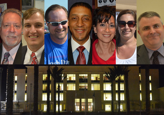 The seven candidates for Flagler County Judge looking to replace Sharon Atack and move into the building below. In alphabetical order from left, Don Appignani, Craig Atack, Josh Davis, Marc Dwyer, Sharon Feliciano, Melissa Moore-Stens, and W. Scott Westbrook. (© FlaglerLive)