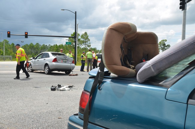 The child seat was taken out of the Mercury and placed on the trunk by emergency personnel and was unoccupied when the wreck took place. Click on the image for larger view. (© FlaglerLive)